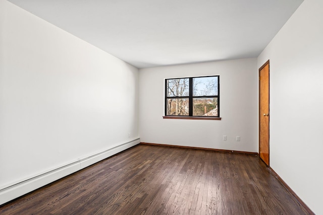 empty room featuring a baseboard radiator and dark hardwood / wood-style flooring