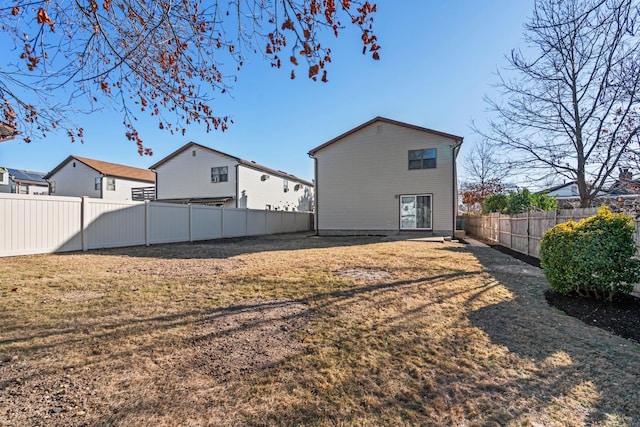 rear view of house featuring a lawn