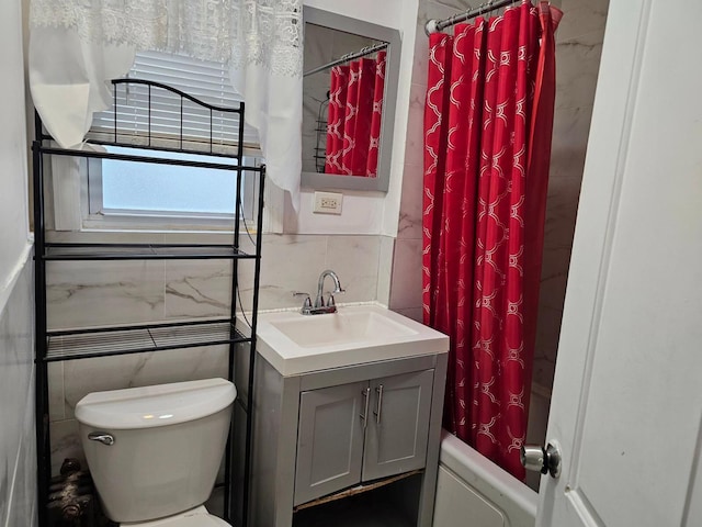 bathroom with vanity, tile walls, and shower / bath combo with shower curtain