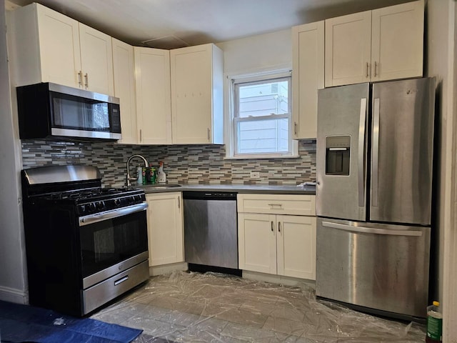 kitchen with white cabinetry, sink, decorative backsplash, and appliances with stainless steel finishes