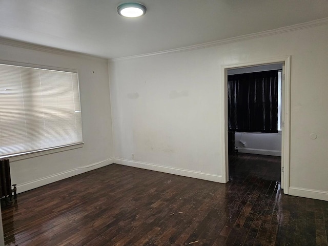 empty room with dark hardwood / wood-style flooring and ornamental molding