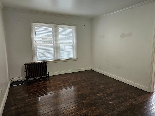 empty room featuring dark hardwood / wood-style flooring, radiator heating unit, and ornamental molding