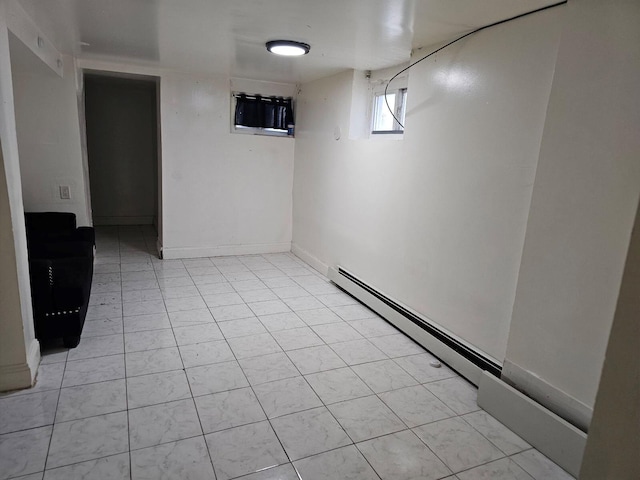 basement with a baseboard radiator and light tile patterned floors