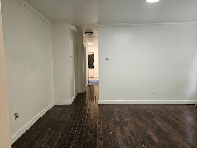 spare room with crown molding and dark hardwood / wood-style flooring