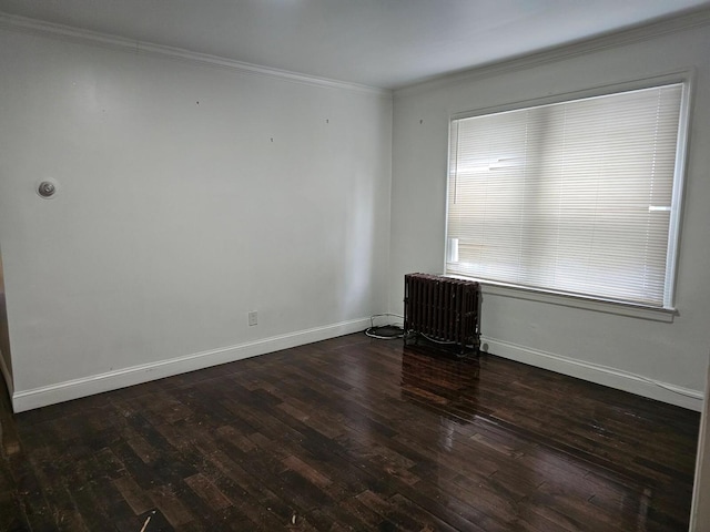 unfurnished room featuring dark wood-type flooring, radiator heating unit, and ornamental molding