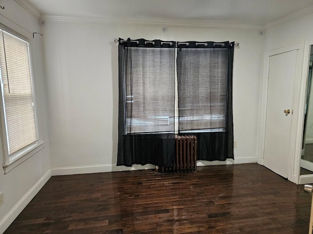 unfurnished room with crown molding and dark wood-type flooring