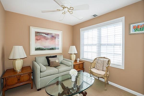 sitting room with light colored carpet and ceiling fan