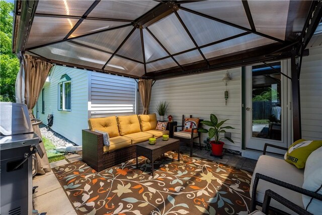 wooden terrace featuring an outdoor living space and a gazebo