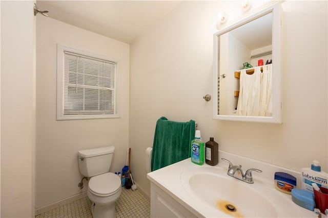 bathroom featuring tile patterned floors, vanity, and toilet