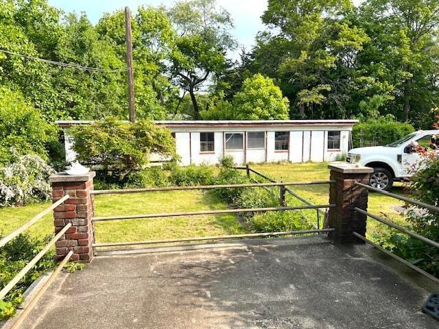 view of gate featuring a yard