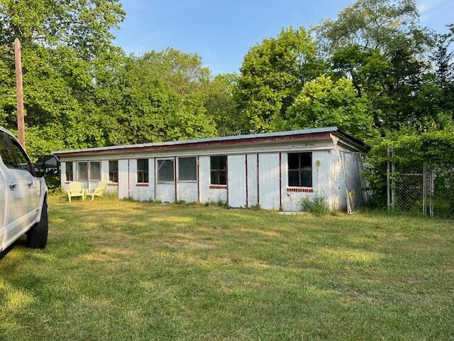 view of outbuilding featuring a lawn