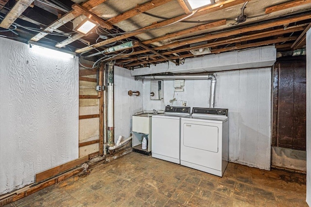 basement with separate washer and dryer and sink