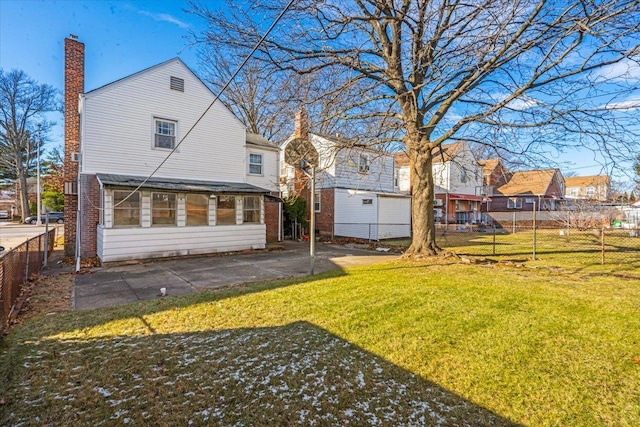 back of house featuring a lawn and a patio