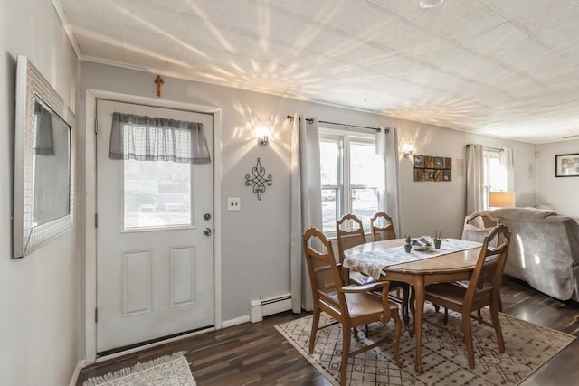 dining room featuring a baseboard heating unit and dark wood-type flooring