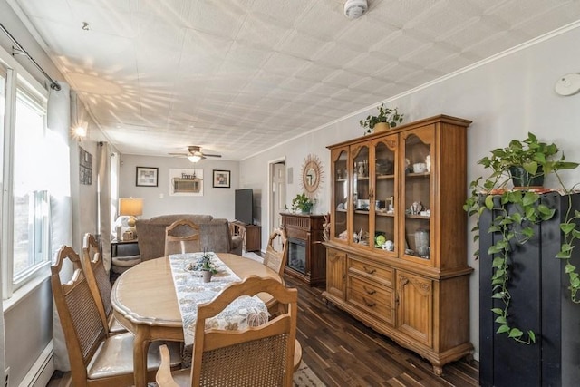 dining space featuring ceiling fan, ornamental molding, dark hardwood / wood-style flooring, and baseboard heating