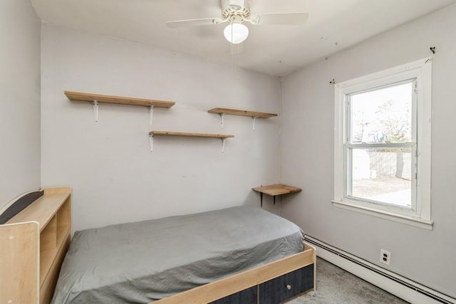 carpeted bedroom with a baseboard radiator and ceiling fan