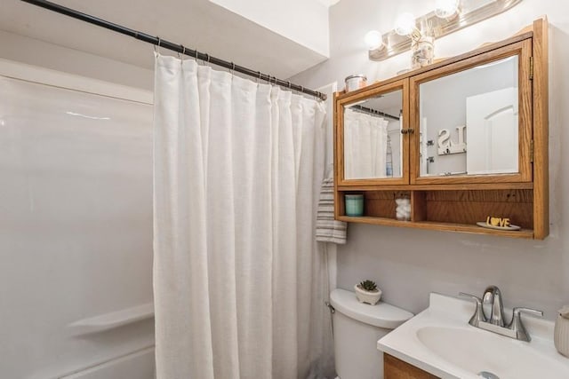 bathroom featuring vanity, toilet, and a shower with shower curtain