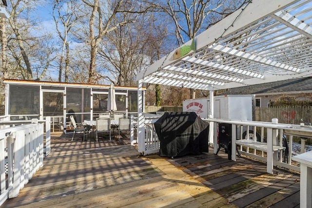 wooden terrace with a pergola and a sunroom