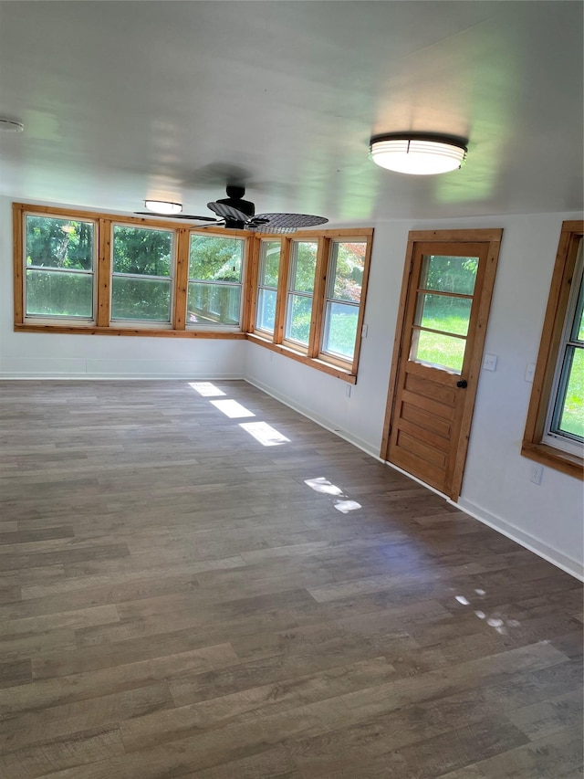 interior space with dark hardwood / wood-style floors and ceiling fan