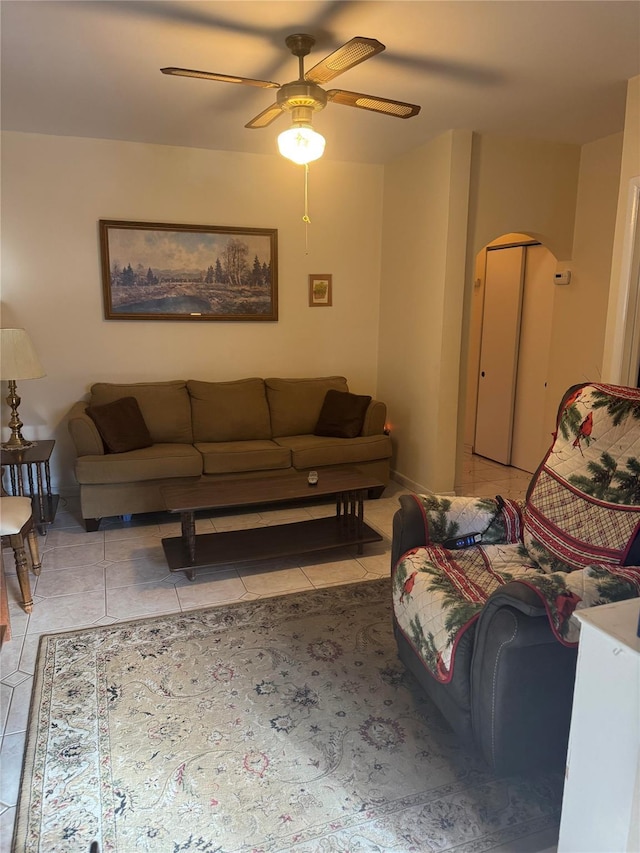 tiled living room with ceiling fan