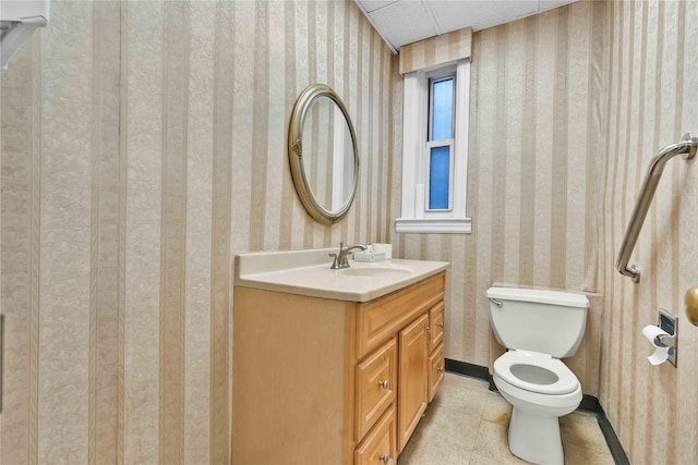 bathroom featuring tile patterned flooring, vanity, and toilet