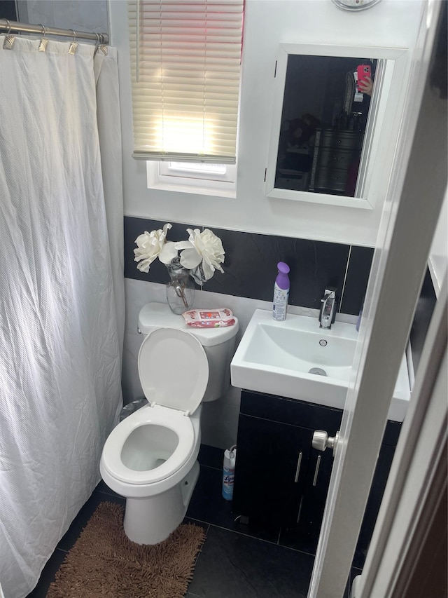 bathroom featuring vanity, tile patterned floors, and toilet