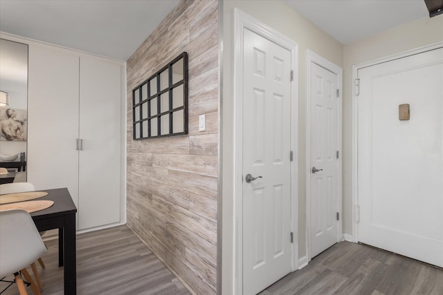 interior space featuring hardwood / wood-style floors and wood walls