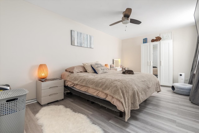 bedroom with ceiling fan and light hardwood / wood-style floors