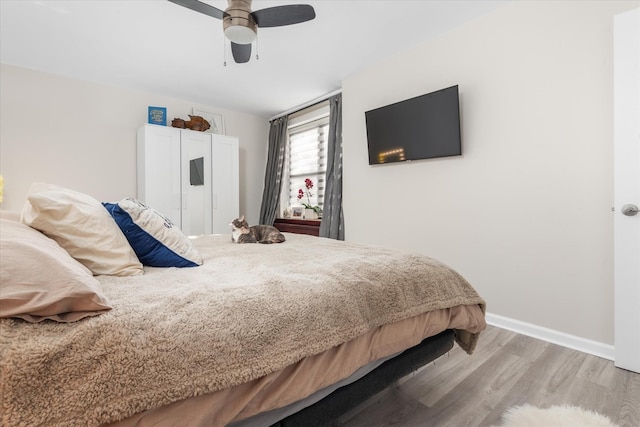 bedroom with ceiling fan and light hardwood / wood-style flooring