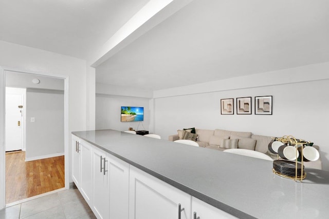 kitchen featuring white cabinetry and light tile patterned flooring