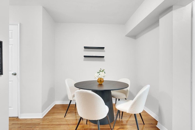 dining space with hardwood / wood-style flooring