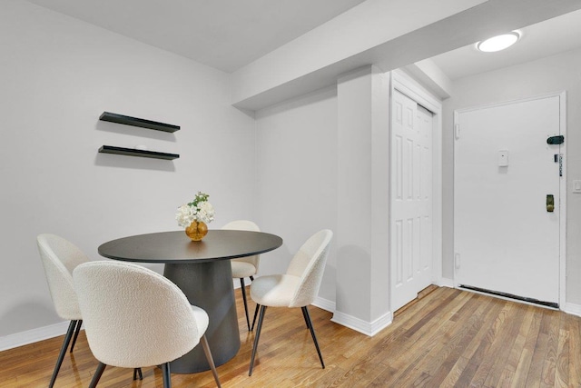 dining space featuring wood-type flooring