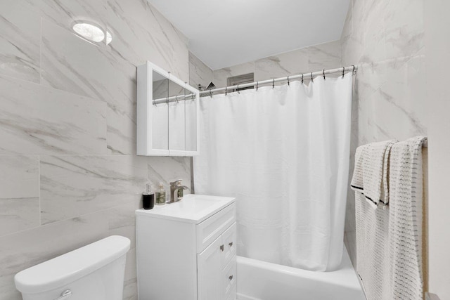 full bathroom with vanity, tile walls, shower / tub combo with curtain, and toilet