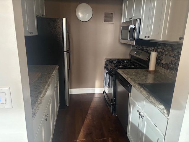 1 Landmark Sq Unit 302, Port Chester, NY 10573 - kitchen featuring sink, white cabinetry, appliances with stainless steel finishes, dark hardwood / wood-style flooring, and backsplash