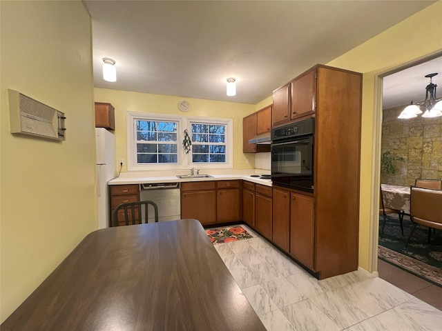 kitchen with white appliances, decorative light fixtures, a chandelier, and sink