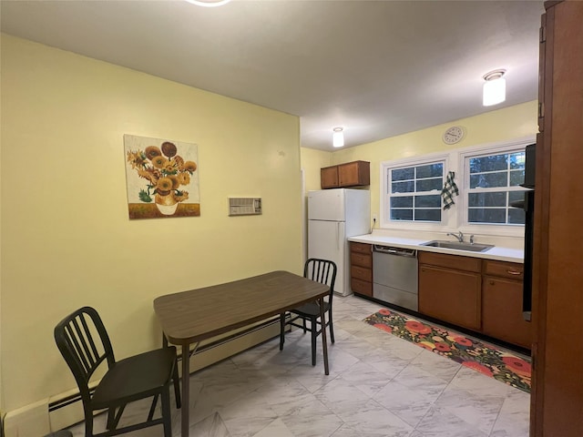 kitchen featuring dishwasher, white fridge, sink, and a baseboard radiator