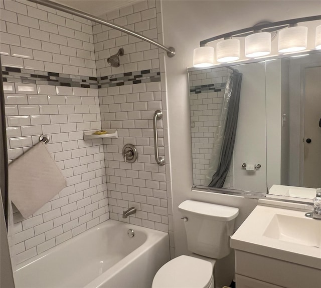 full bathroom with vanity, tiled shower / bath, and toilet