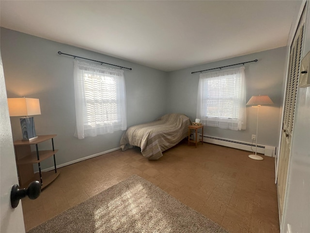 bedroom featuring hardwood / wood-style floors and baseboard heating