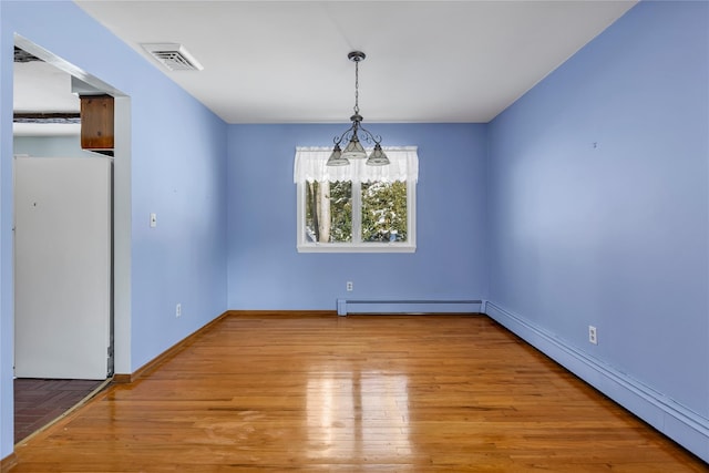 unfurnished dining area with a baseboard radiator and light hardwood / wood-style floors