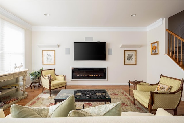 living room with ornamental molding and light wood-type flooring