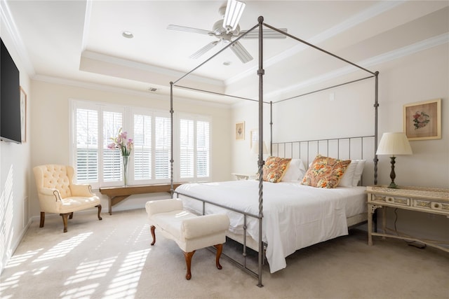 bedroom with ceiling fan, ornamental molding, a raised ceiling, and carpet floors