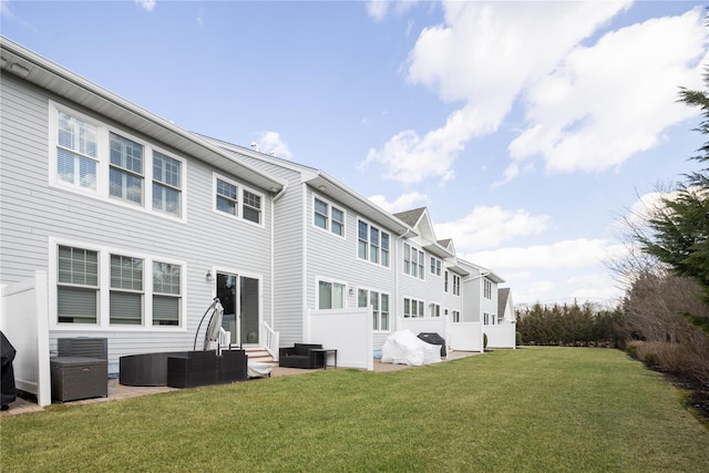 back of house with a patio area, a lawn, and central air condition unit