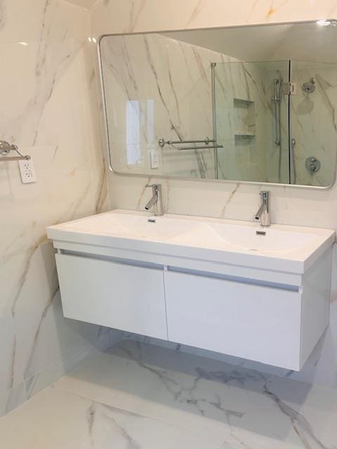 bathroom featuring vanity and a tile shower