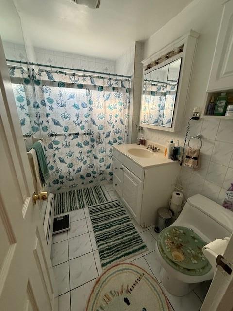 bathroom featuring tile walls, a shower with shower curtain, vanity, tile patterned floors, and toilet