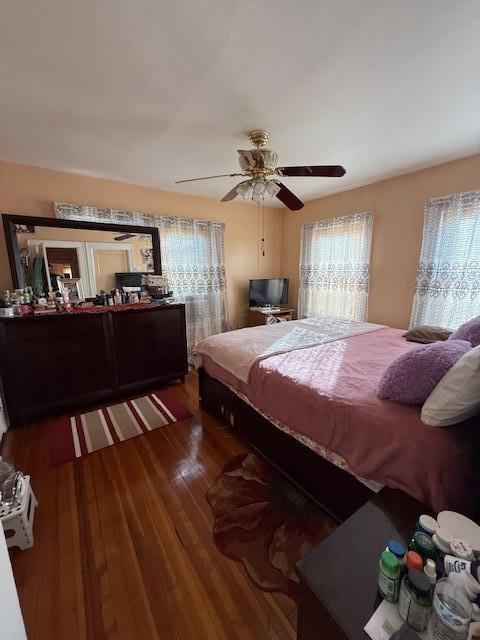 bedroom with dark wood-type flooring and ceiling fan