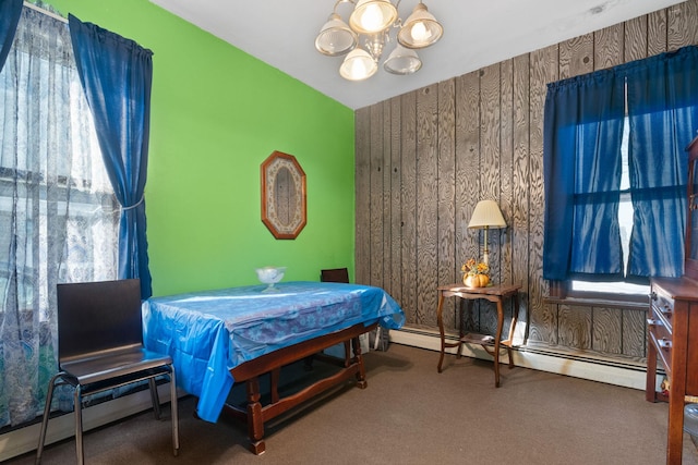 carpeted bedroom featuring a baseboard radiator and a chandelier