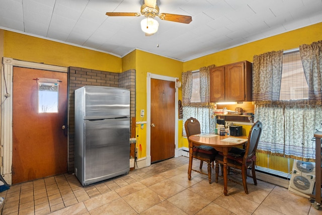 kitchen with stainless steel refrigerator, ceiling fan, baseboard heating, and light tile patterned floors