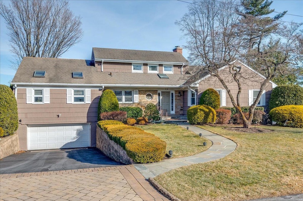 view of front of house with a garage and a front lawn