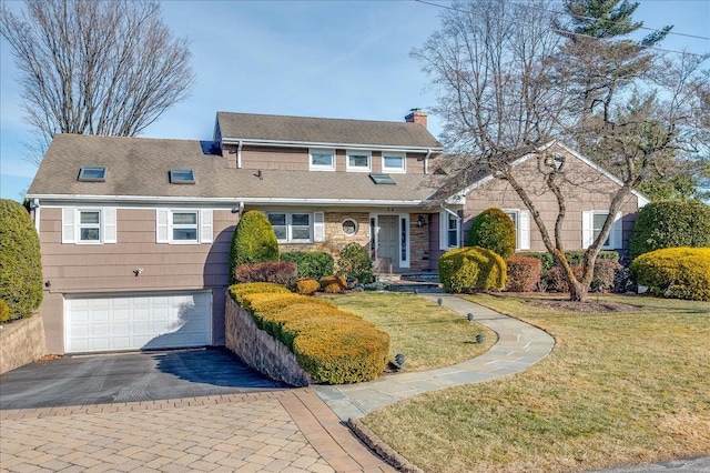 view of front of house with a garage and a front lawn