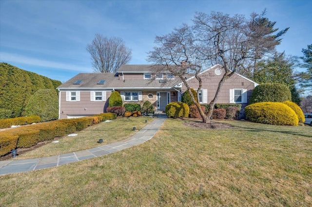 view of front facade featuring a garage and a front lawn